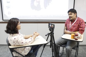 A participant conducting a mock interview from another attendee about creating the perfect peanut butter and jelly sandwich during the Multimedia-Interactive Storytelling session