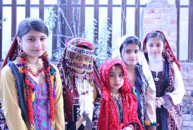 Girls dressed up in traditional Balochi and Sindhi cultural dresses attend the second day of Cultural Diversity Expo on Friday, December 27, 2013. 