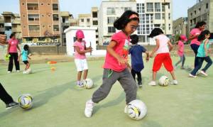 A young participant of the Go Girl Pakistan project practices her football skills