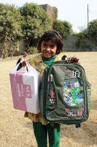 Zainab who hopes to become a doctor when she grows up, showing off her new school bag