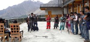 Students shooting a mock talk show on camera