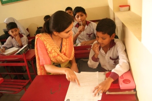 Discovering New Artists’ (DNA) Communication Manager Arooj Aurangzeb giving instructions to a student during the contest at Hope Uplift Foundation school on Friday, 25th October, 2013 in Lahore, Pakistan. “Jeet Key Perhao” Creative Writing Competition was funded by an Alumni Small Grant from the Pakistan-U.S Alumni Network.