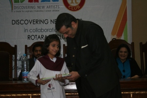 PTI MPA Murad Rass awards a book to a student from Hope Uplift Foundation during the prize distribution ceremony of “Jeet Key Perhao” Creative Writing Competition at Forman Christian College on Friday, December 6th, 2013 in Lahore, Pakistan.  About 15 students were declared winners out of which 12 were awarded handsome scholarships. Course books, story books and uniforms were also a part of the prizes. 