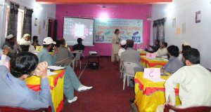 Alumnus Nazeer Ahmed interacting with male students during an activity in the workshop