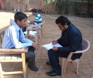 A mentor asking a series of questions from a student at Merry Rose School