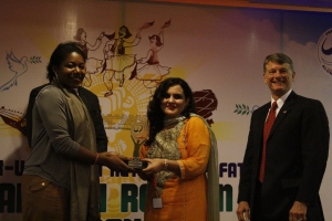 AEIF Winner Sana Ejaz receiving an award from Deputy PAO Kedenard Raymond