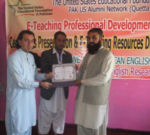 (From Left to Right) Alumnus Nazeer Ahmed and District Education Officer Kaleem Shah giving a certificate to a male participant