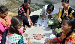 Female students enjoying creating an art exhibit during a Rabtt Summer Camp 2014