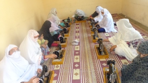 Participants working on their sewing machines during the workshop in June