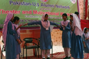 Students role-playing a situation in front of a live audience at the government school in Liaquatabad