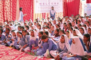 Students watching the acts during the theatre workshop at the government school in Liaquatabad