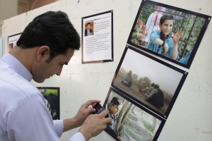 A visitor to the Grand Exhibition taking a snap of a student’s photograph 