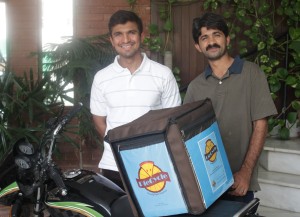 Azhar Zaheer with his delivery guy and the motorcycle on which the pies are delivered